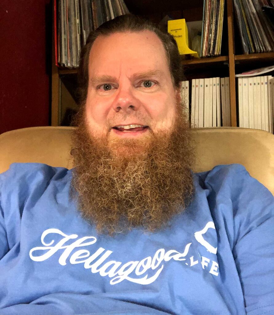 Dale just relaxing in chair sporting a blue Hellagood Life t-shirt