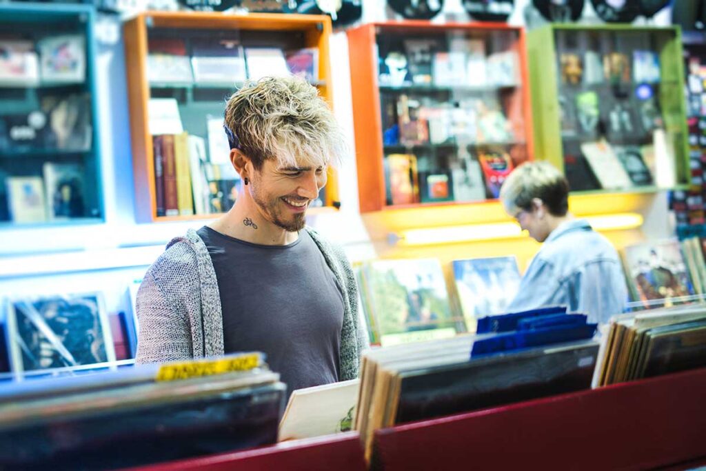 psychology of buying things - guy buying records in a record shop