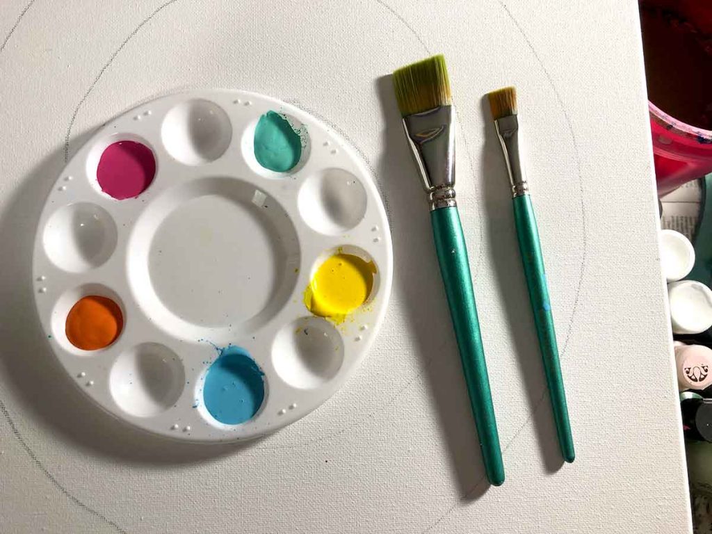 Paint brushes, canvas and paints.